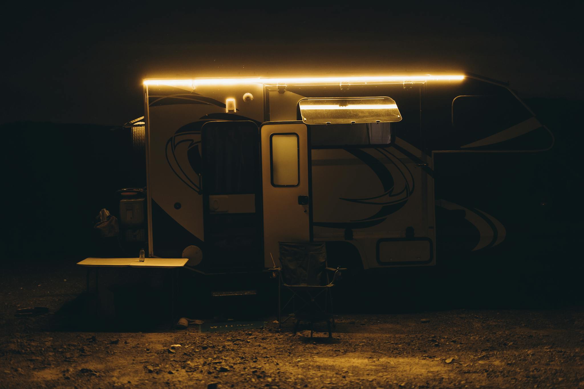 Illuminated camper scene in the Dubai desert offering a warm, inviting vibe for nighttime adventure enthusiasts.